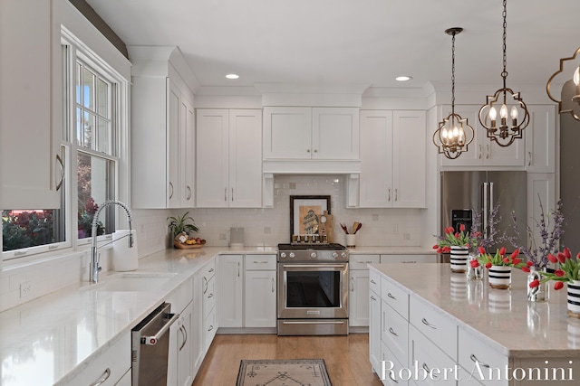 3794 Lake Birch St NE, Grand Rapids, MI 49525 - kitchen featuring stainless steel appliances, a chandelier, white cabinets, pendant lighting, and recessed lighting