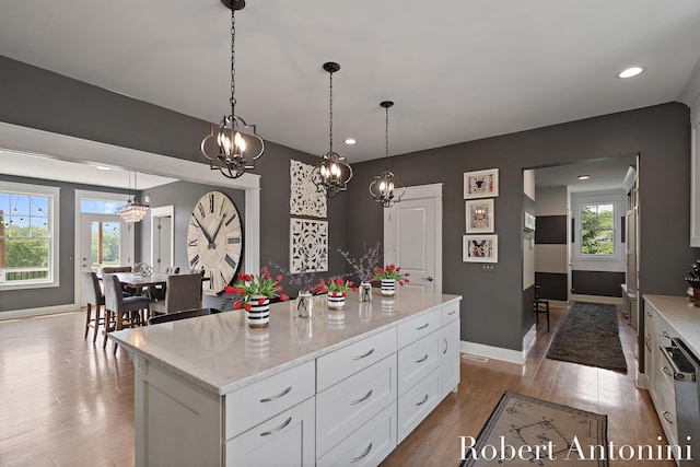 3794 Lake Birch St NE, Grand Rapids, MI 49525 - kitchen featuring white cabinets, light wood-style flooring, plenty of natural light, and recessed lighting