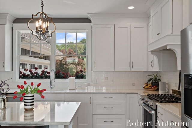 3794 Lake Birch St NE, Grand Rapids, MI 49525 - kitchen featuring stainless steel appliances, a chandelier, white cabinets, and recessed lighting