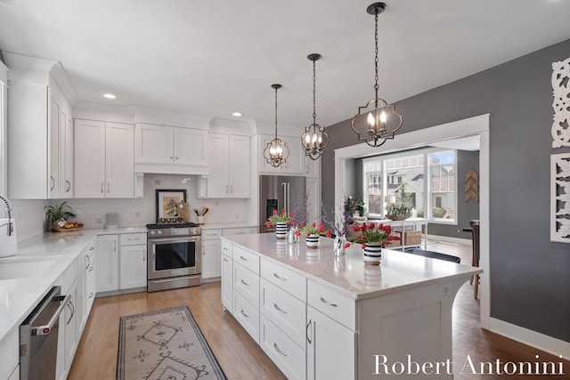 3794 Lake Birch St NE, Grand Rapids, MI 49525 - kitchen featuring stainless steel appliances, decorative backsplash, light wood-type flooring, white cabinets, and recessed lighting