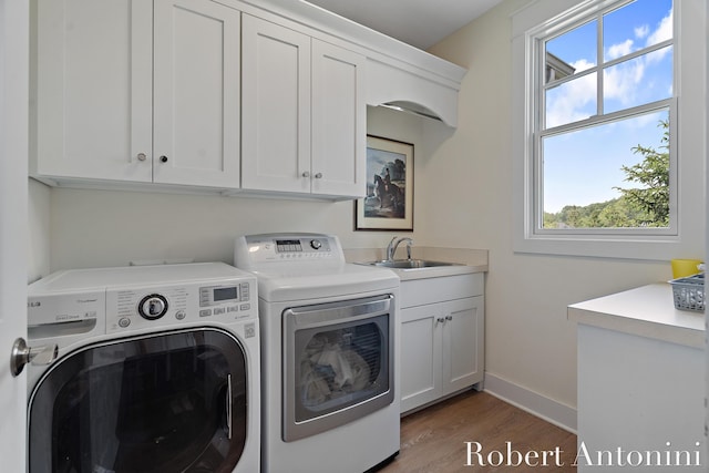 3794 Lake Birch St NE, Grand Rapids, MI 49525 - laundry area with cabinet space, independent washer and dryer, plenty of natural light, and wood finished floors
