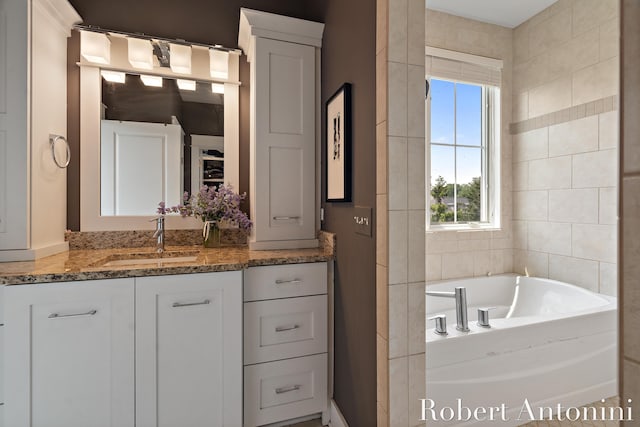 3794 Lake Birch St NE, Grand Rapids, MI 49525 - bathroom featuring vanity, a garden tub, and tile walls