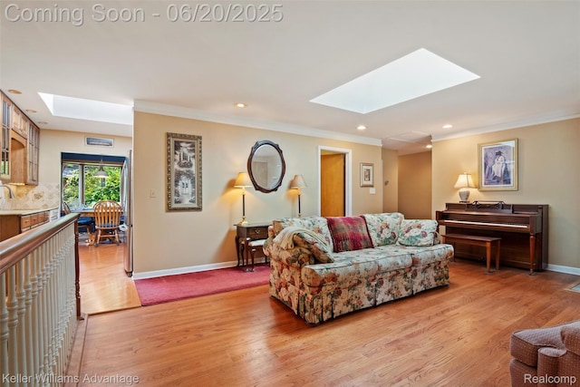 34030 Hampshire St, Livonia, MI 48154 - living area with a skylight, light wood-style flooring, ornamental molding, and recessed lighting