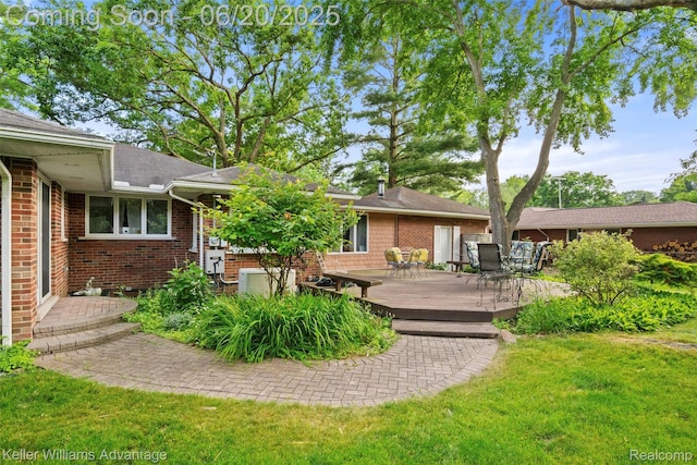 34030 Hampshire St, Livonia, MI 48154 - rear view of house with a wooden deck, a yard, brick siding, outdoor dining space, and roof with shingles
