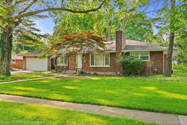 34030 Hampshire St, Livonia, MI 48154 - view of front of home with brick siding, an attached garage, and a front lawn