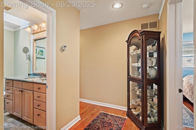 34030 Hampshire St, Livonia, MI 48154 - ensuite bathroom featuring wood finished floors and vanity