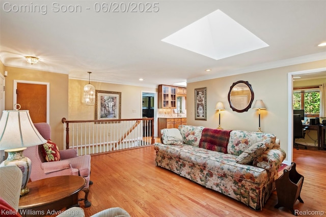 34030 Hampshire St, Livonia, MI 48154 - living area with a skylight, light wood-type flooring, ornamental molding, and recessed lighting