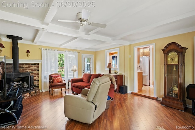 34030 Hampshire St, Livonia, MI 48154 - living room with a wood stove, coffered ceiling, hardwood / wood-style floors, beamed ceiling, and a ceiling fan