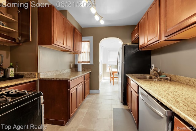136 Alice Ave, Bloomfield Hills, MI 48302 - kitchen with dishwasher, black gas range, arched walkways, light tile patterned flooring, and brown cabinetry