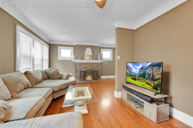 136 Alice Ave, Bloomfield Hills, MI 48302 - living room with wood finished floors, a fireplace with flush hearth, and a textured ceiling