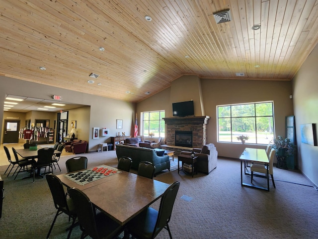 8456 Torreyhill Ct, Elmira, MI 49730 - dining area with carpet flooring, wooden ceiling, a stone fireplace, and lofted ceiling