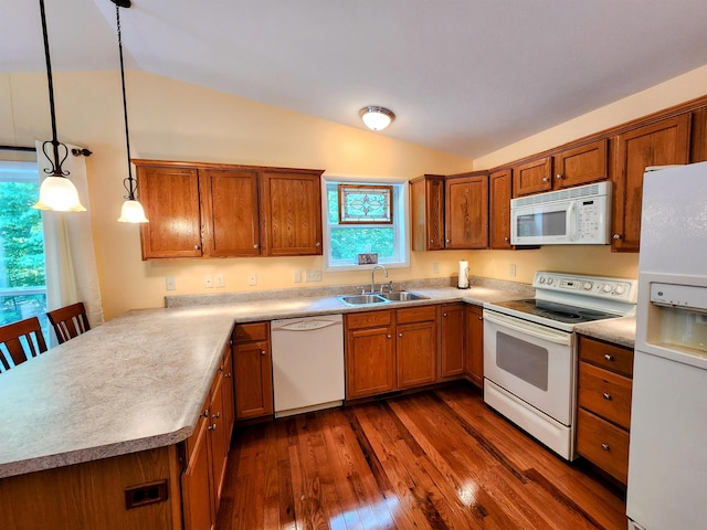 8456 Torreyhill Ct, Elmira, MI 49730 - kitchen with white appliances, vaulted ceiling, a peninsula, brown cabinets, and dark wood-style floors
