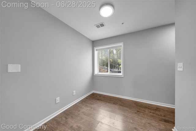 41606 Hamlet Ln, Novi, MI 48375 - spare room with dark wood finished floors and vaulted ceiling