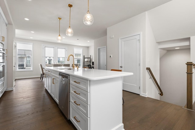 2949 Aughton Rd, Ann Arbor, MI 48105 - kitchen featuring appliances with stainless steel finishes, dark wood finished floors, an island with sink, light countertops, and white cabinets