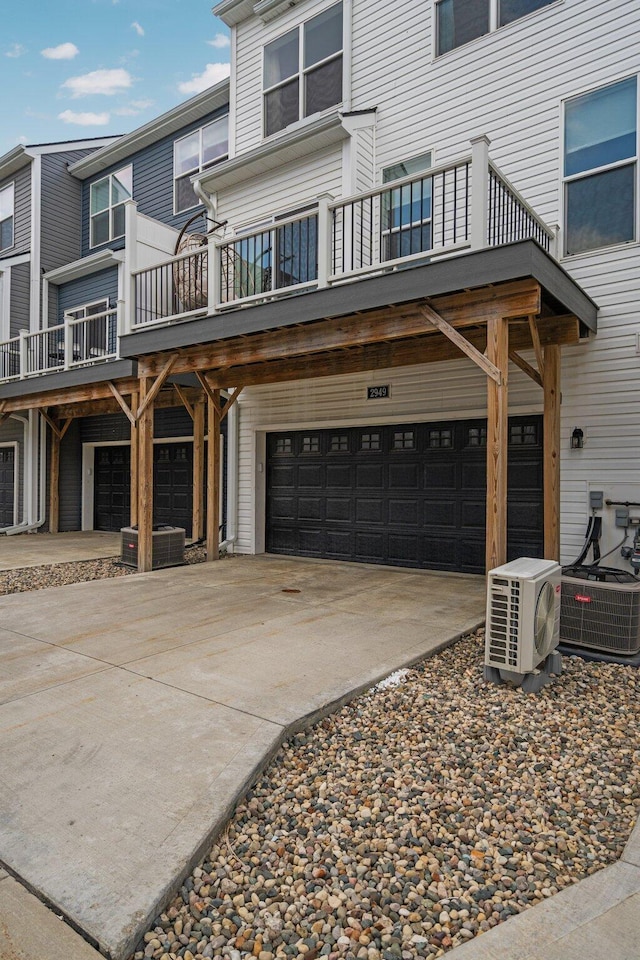2949 Aughton Rd, Ann Arbor, MI 48105 - view of front facade featuring an attached garage, concrete driveway, and a balcony
