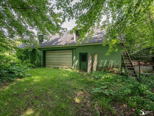 15000 Minx Rd, Monroe, MI 48161 - rear view of property with stairs, roof with shingles, stucco siding, and driveway