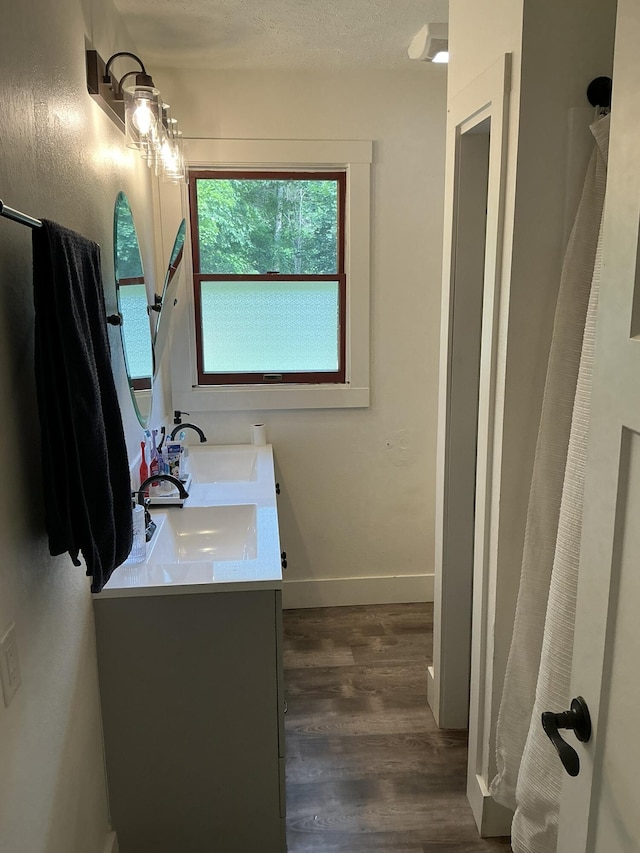 2383 Holton Rd, Muskegon, MI 49445 - bathroom with double vanity and wood finished floors