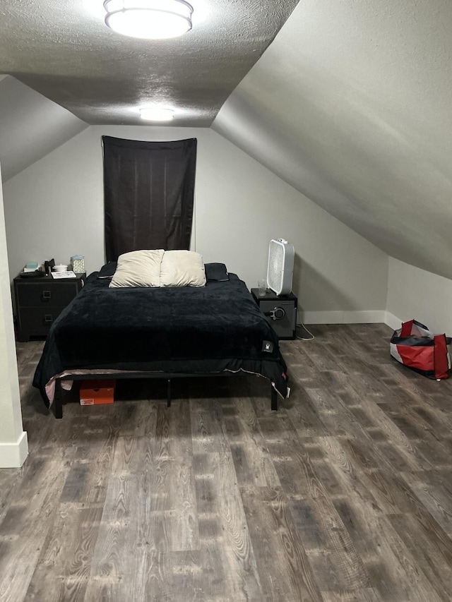 2383 Holton Rd, Muskegon, MI 49445 - bedroom featuring wood finished floors, lofted ceiling, and a textured ceiling