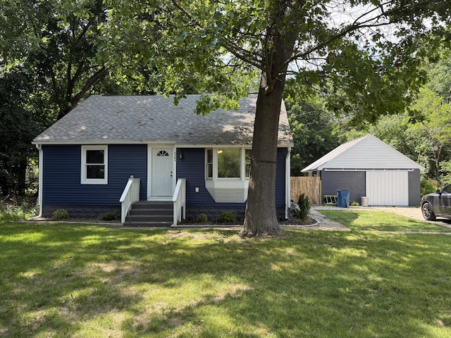 2383 Holton Rd, Muskegon, MI 49445 - view of front of home featuring a front lawn, a shingled roof, and an outbuilding