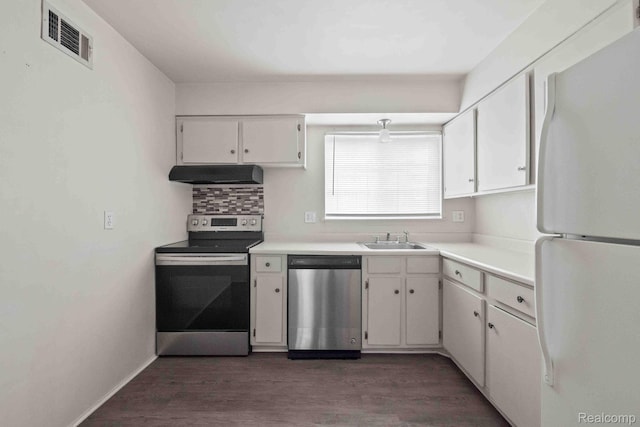 25316 Shiawassee Cir Unit 103, Southfield, MI 48033 - kitchen with stainless steel appliances, exhaust hood, white cabinets, dark wood-style floors, and light countertops