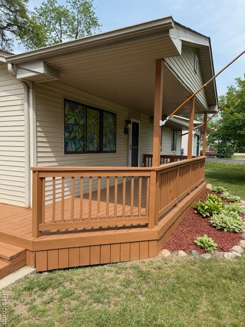 5496 Elizabeth Lake Rd, Waterford, MI 48327 - wooden porch with a yard