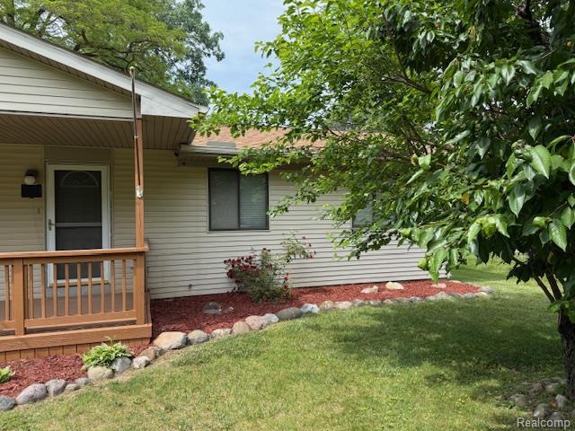 5496 Elizabeth Lake Rd, Waterford, MI 48327 - view of side of home featuring a yard and covered porch