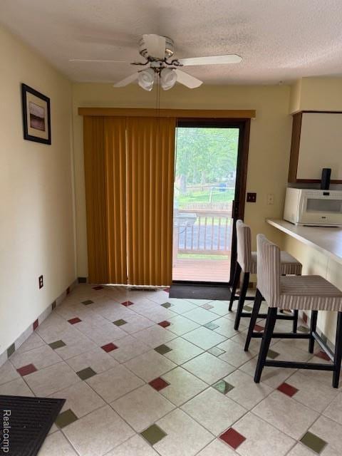 5496 Elizabeth Lake Rd, Waterford, MI 48327 - dining area with ceiling fan and light tile patterned flooring