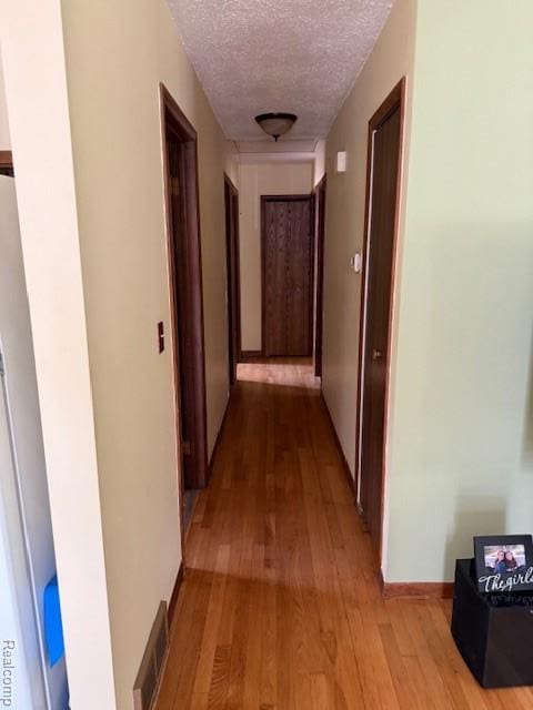 5496 Elizabeth Lake Rd, Waterford, MI 48327 - hallway with a textured ceiling and wood finished floors