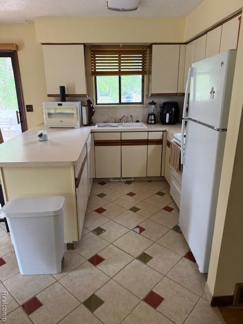 5496 Elizabeth Lake Rd, Waterford, MI 48327 - kitchen featuring white appliances, light countertops, a peninsula, and light tile patterned floors