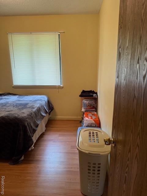 5496 Elizabeth Lake Rd, Waterford, MI 48327 - bedroom featuring wood finished floors and baseboards