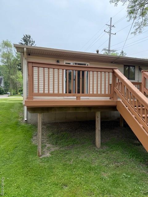 5496 Elizabeth Lake Rd, Waterford, MI 48327 - back of house featuring a yard and a wooden deck