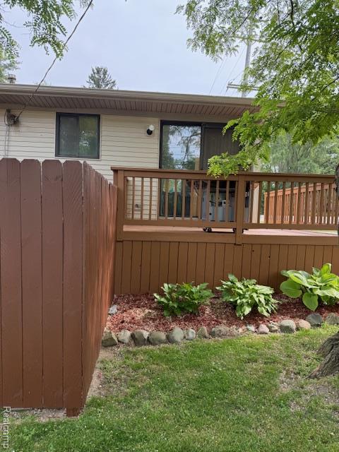 5496 Elizabeth Lake Rd, Waterford, MI 48327 - back of house featuring a wooden deck