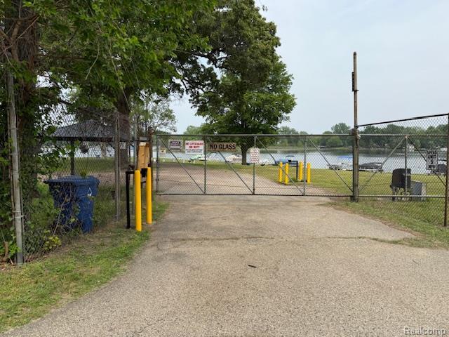 5496 Elizabeth Lake Rd, Waterford, MI 48327 - view of street featuring a gate and a water view