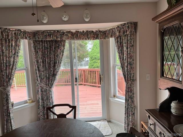 912 Rikki Anne Ct, Wixom, MI 48393 - carpeted dining area featuring ceiling fan and baseboards