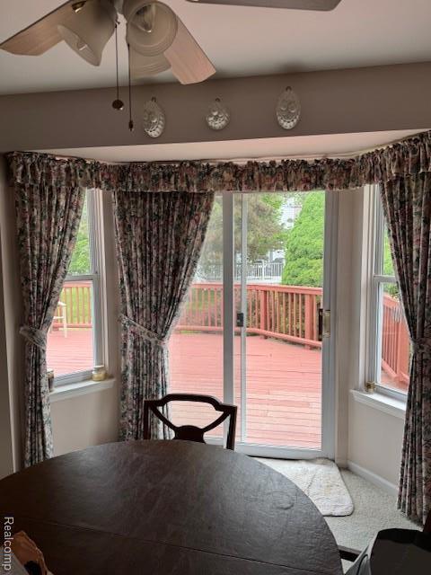 912 Rikki Anne Ct, Wixom, MI 48393 - dining area with a ceiling fan, carpet floors, and plenty of natural light