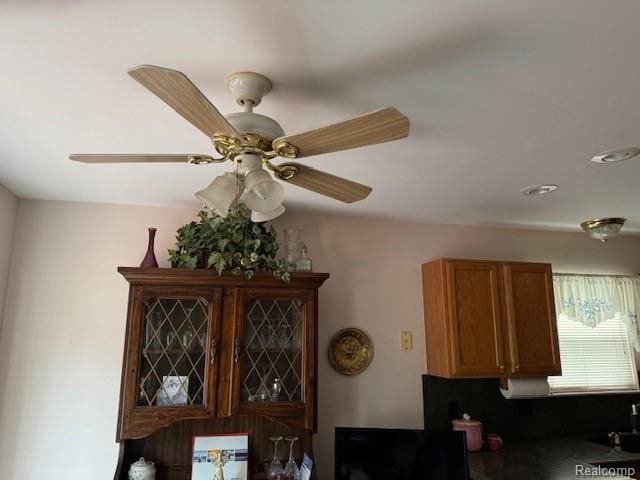 912 Rikki Anne Ct, Wixom, MI 48393 - kitchen view of a ceiling fan and brown cabinets