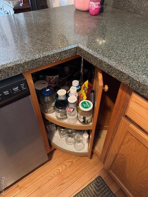 912 Rikki Anne Ct, Wixom, MI 48393 - kitchen view of dishwasher, dark countertops, and light wood-type flooring