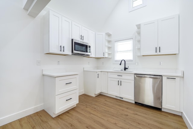 21611 Conners Ave, Warren, MI 48091 - kitchen with stainless steel appliances, open shelves, light wood-type flooring, and lofted ceiling