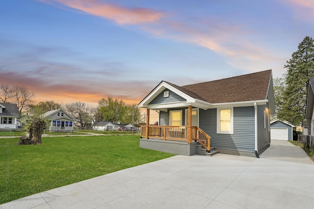 21611 Conners Ave, Warren, MI 48091 - view of front facade with driveway, a porch, an outdoor structure, a garage, and a shingled roof