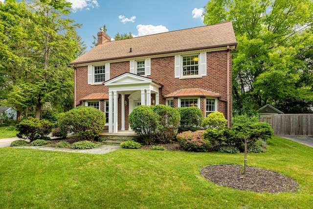 1208 Whittier Rd, Ypsilanti, MI 48197 - colonial home with a chimney and brick siding