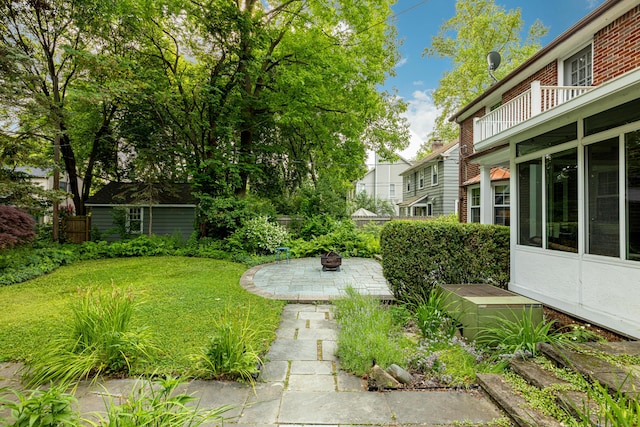 1208 Whittier Rd, Ypsilanti, MI 48197 - view of green lawn featuring an outdoor fire pit and a patio