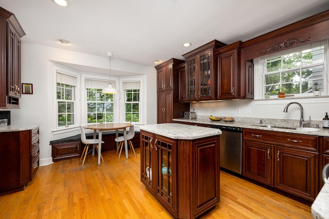 1208 Whittier Rd, Ypsilanti, MI 48197 - kitchen featuring stainless steel dishwasher, light wood-style floors, pendant lighting, glass insert cabinets, and recessed lighting