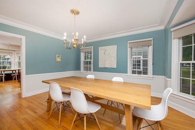 1208 Whittier Rd, Ypsilanti, MI 48197 - dining room featuring a chandelier, plenty of natural light, a wainscoted wall, light wood-style floors, and ornamental molding