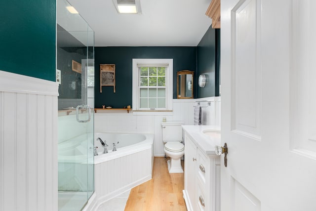1208 Whittier Rd, Ypsilanti, MI 48197 - full bath featuring a bath, a shower stall, wainscoting, wood finished floors, and vanity