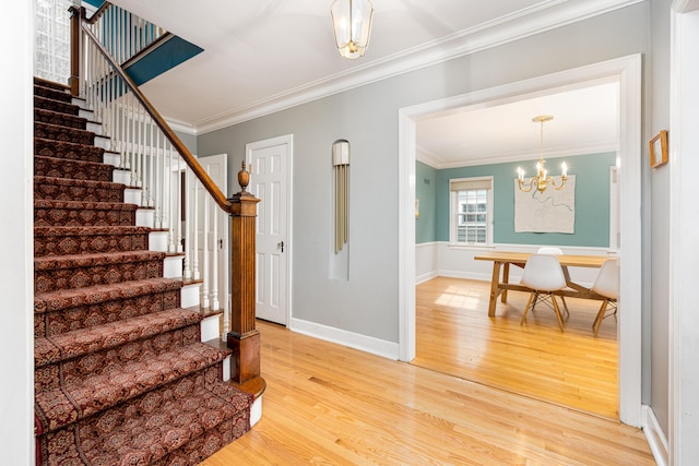 1208 Whittier Rd, Ypsilanti, MI 48197 - stairs with wood finished floors, ornamental molding, and a chandelier