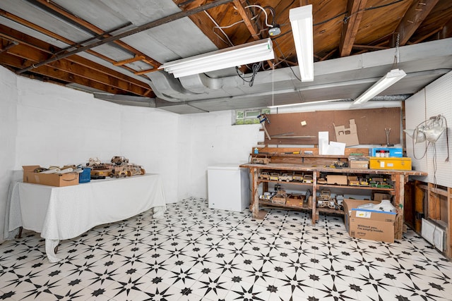 1208 Whittier Rd, Ypsilanti, MI 48197 - below grade area with a workshop area, tile patterned floors, and refrigerator