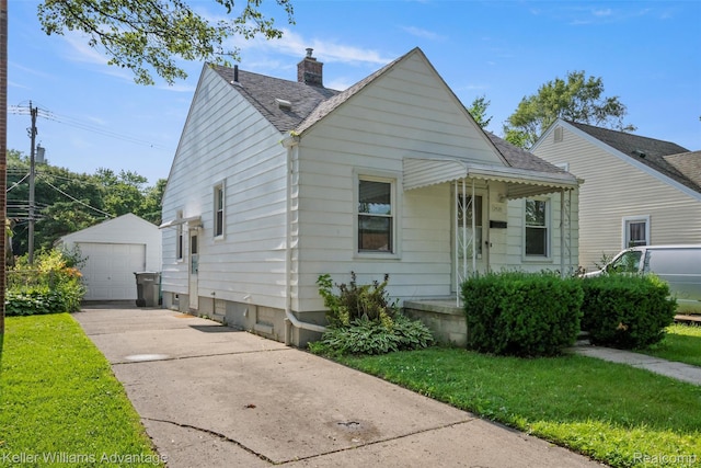 3434 Campbell St, Dearborn, MI 48124 - view of front of home featuring an outdoor structure, a detached garage, roof with shingles, a chimney, and a front yard