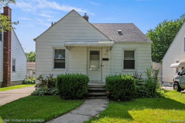 3434 Campbell St, Dearborn, MI 48124 - bungalow-style home featuring roof with shingles, a front yard, and a chimney