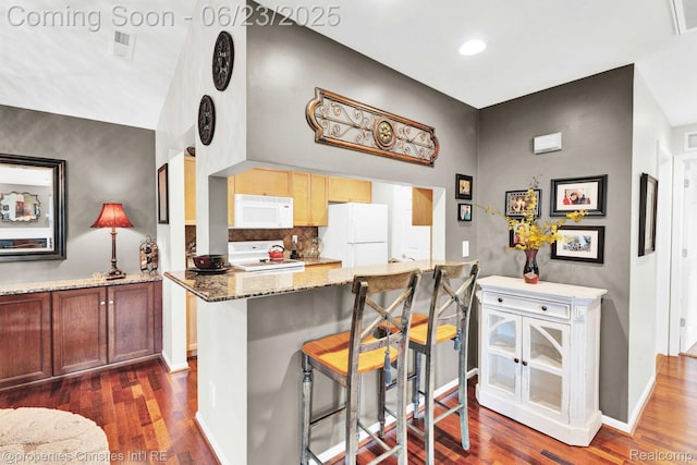 3581 Oakmonte Blvd Unit 60, Rochester, MI 48306 - kitchen with white appliances, a breakfast bar area, dark wood-type flooring, stone countertops, and recessed lighting