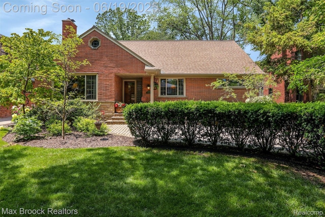 25845 Salem Rd, Huntington Woods, MI 48070 - view of front of house featuring brick siding, a front yard, a chimney, and a shingled roof